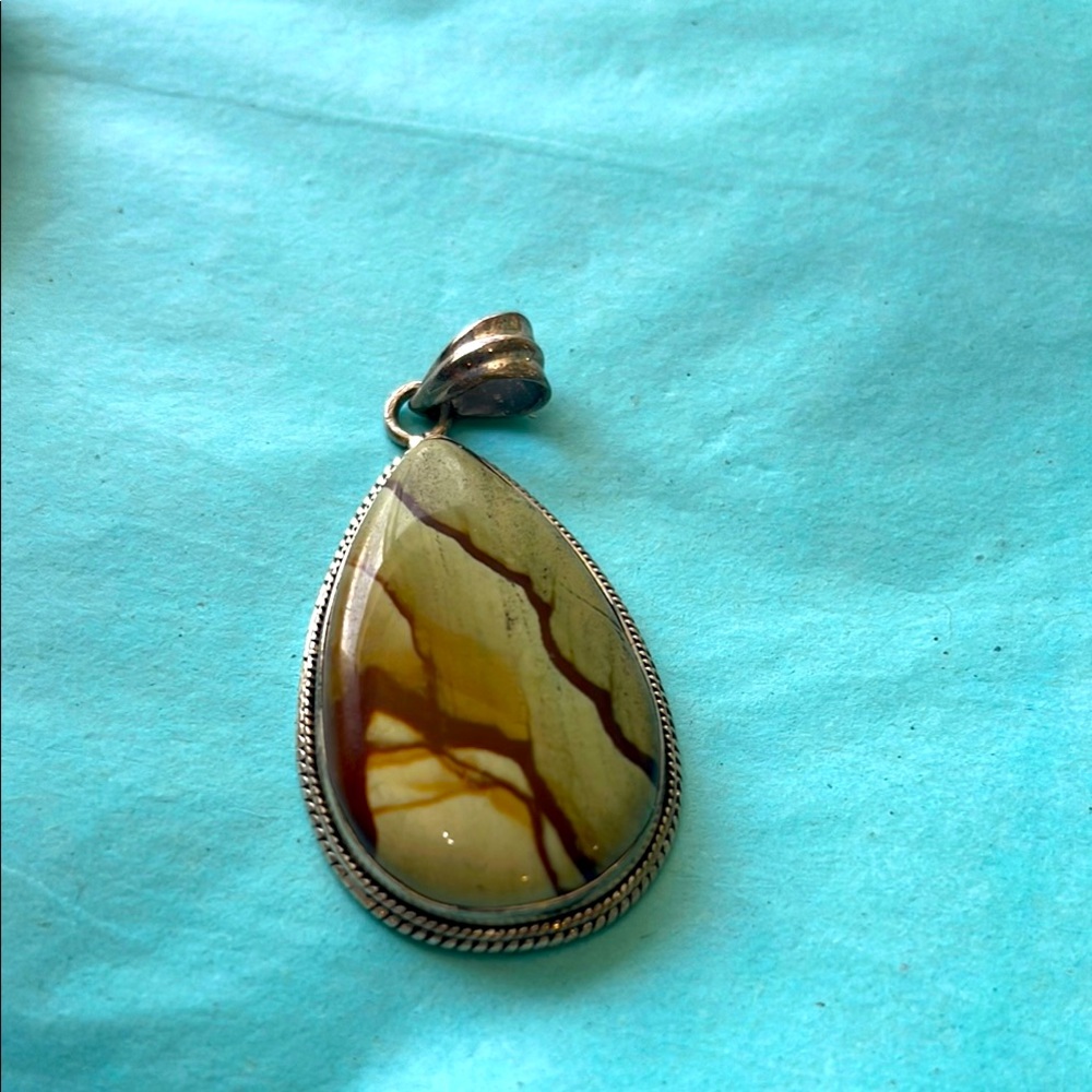 Jasper like Stone Mix of greens and browns seems to be wrapped in Sterling silvr